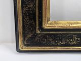 a black and gold picture frame with a gold border
