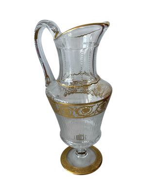 a clear glass vase with gold trimmings on it
