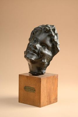 bronze bust of a man on a wooden base