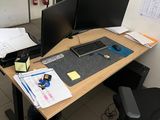 a desk with two monitors and a keyboard on it
