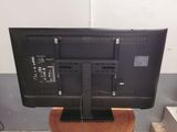 a flat screen tv sitting on top of a wooden stand