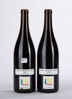 two bottles of wine sitting next to each other on a table