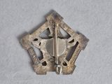 an image of a small metal object on a white surface
