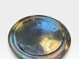 an image of a silver plate on a white surface