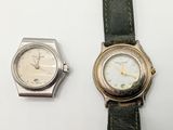 two watches sitting next to each other on a table