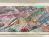 painting of a colorful abstract painting in a white frame on a wall