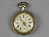 a silver pocket watch with roman numerals on it