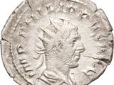 a silver coin with a head of a man on it