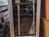 une vitrine contenant un marteau, posée sur une palette