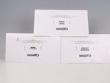 three white envelopes sitting on top of each other on a table