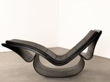 an image of a black leather chair in a white room
