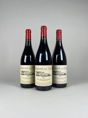 three bottles of wine are lined up on a table
