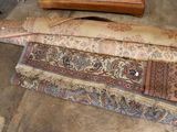 several pieces of carpet on the floor next to a dresser
