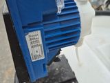 a blue and white water pump on top of a white boat