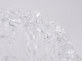 a close up of a glass vase on a white surface
