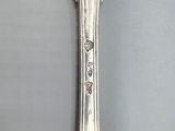 a silver spoon with a spoon handle on it