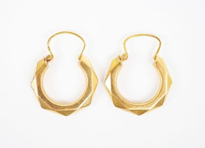 a pair of gold hoop earrings on a white background