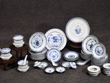 a lot of blue and white plates and bowls on the table