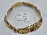 a close up of a gold bracelet with a tag on it