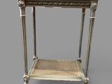 a white table with a wicker shelf on top of it