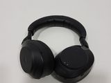 a pair of black headphones on a white surface