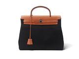 un sac à main en cuir noir et fauve avec une poignée marron