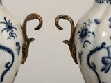 two blue and white vases sitting on a table