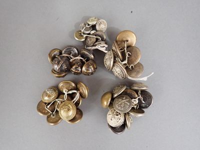 four pieces of silver and gold buttons on a white surface