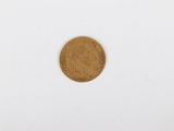 a close up of a gold coin on a white surface