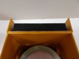 a yellow box with a pink plate inside of it