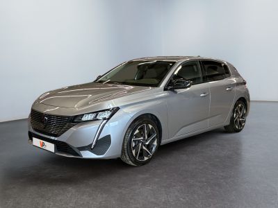 a silver car parked in a room with a white wall