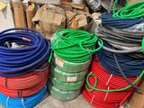 a lot of different colored hoses stacked on top of each other