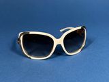 a pair of sunglasses sitting on top of a blue surface