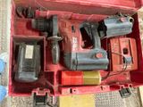 a red tool box with tools in it on the floor