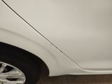 a white car that is parked on the side of the street