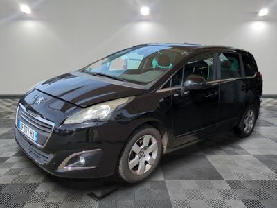 the small black van is parked in a room with a checkered floor