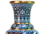 a blue and gold vase sitting on a table