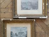 two framed pictures of a city and a church on a wooden wall