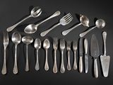 a lot of spoons and forks on a black table