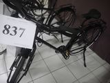 a bicycle that is sitting on the floor with a price tag in front of it