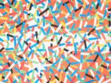 colorful confetti sprinkles on an orange background