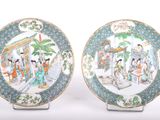 pair of chinese famille plates with figures in a garden