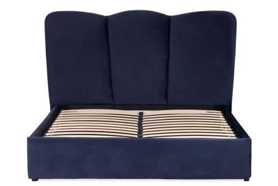 an image of a bed with a blue upholstered headboard and wooden slats