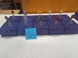 de nombreux petits vases remplis de fleurs, posés sur une table