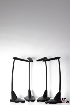 three black lamps that are on a white surface