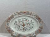 a plate with a floral design on it on a table