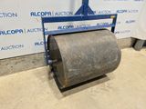 the roller is sitting on the floor in front of the wall