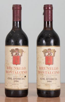 two bottles of wine sitting on top of a table next to each other