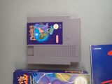 two nintendo games sitting on a table next to each other