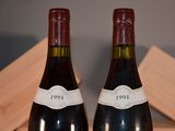 two bottles of wine that are sitting on a table